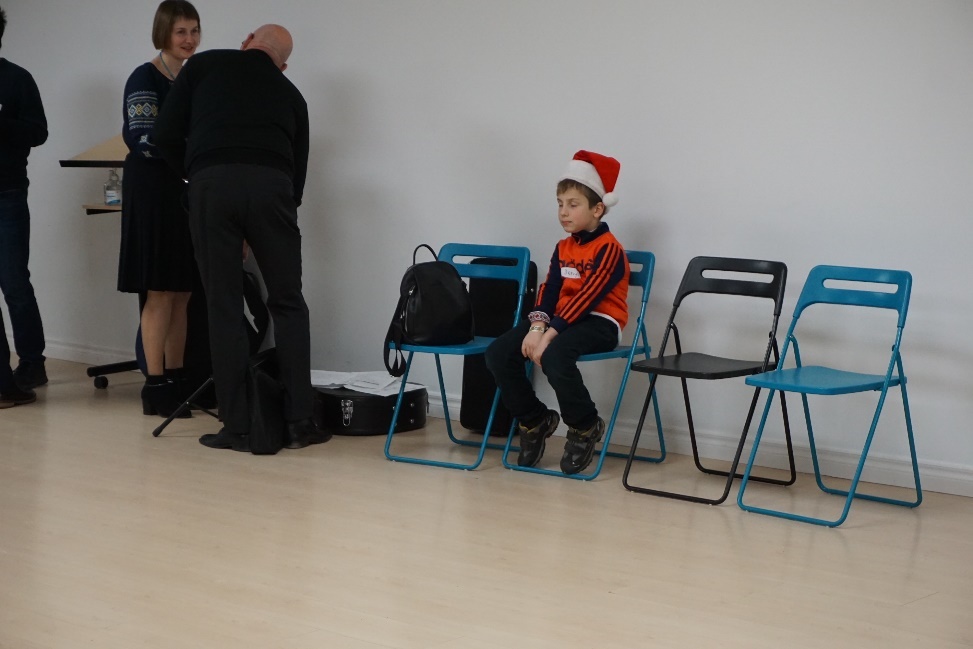 A photo of a child sitting on a chair