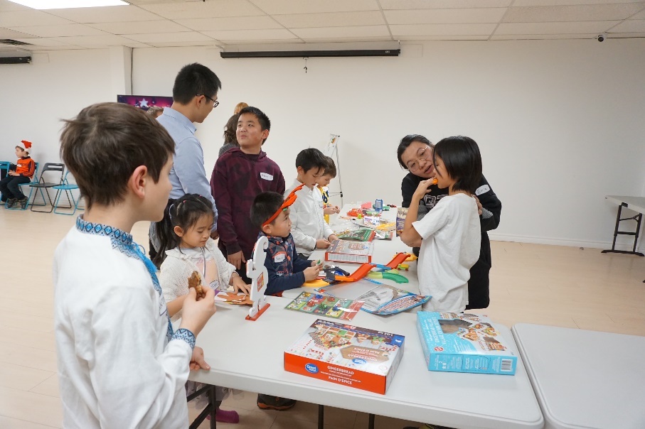 A photo of children and adults interacting with each other
